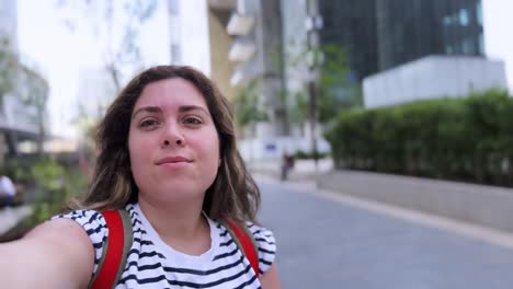 a woman is taking a selfie in front of a building