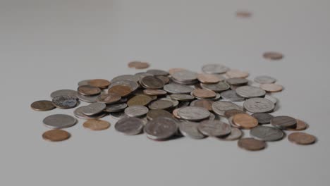 still long take of various coins in a pile