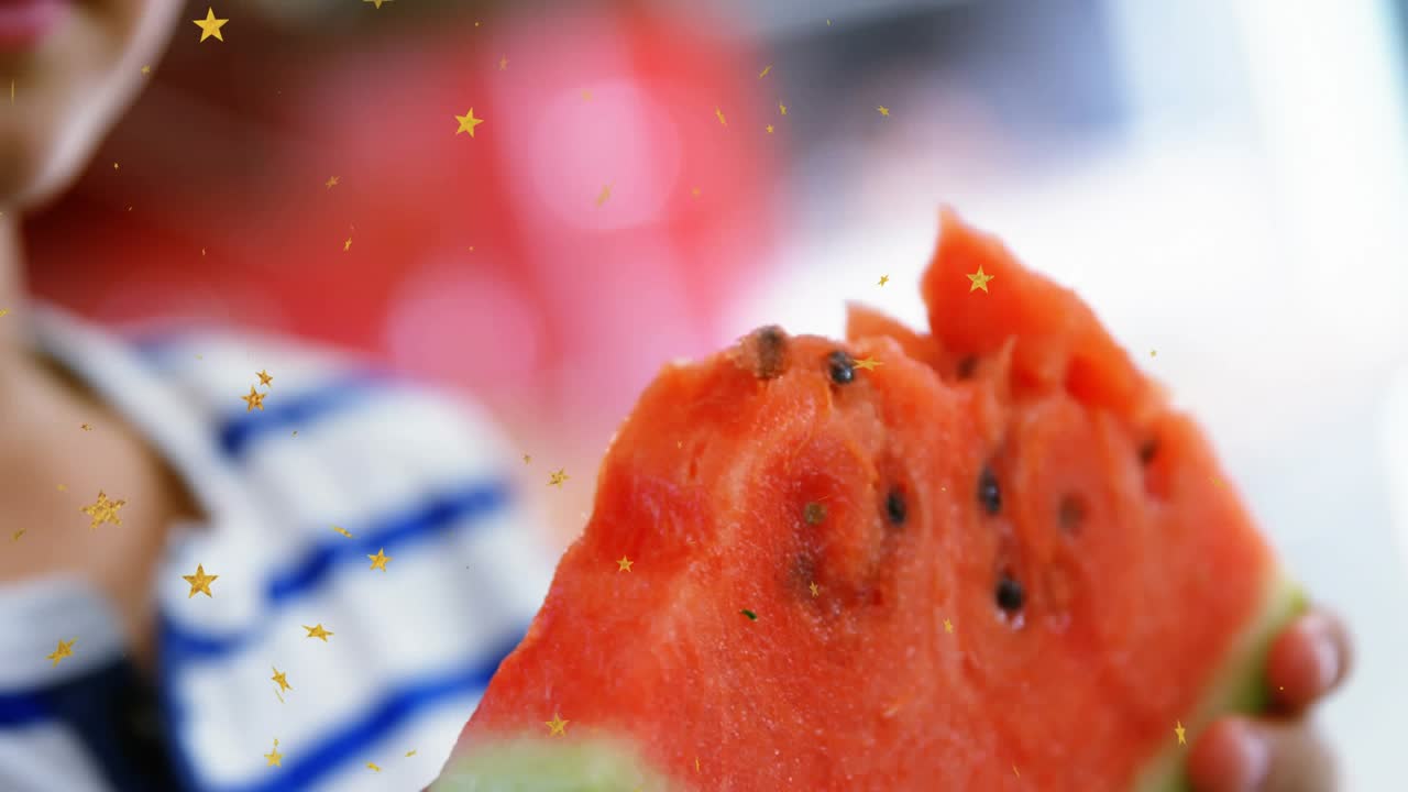 Boy holding watermelon slice in food scene, bringing slice to mouth and biting, gold stars drifting