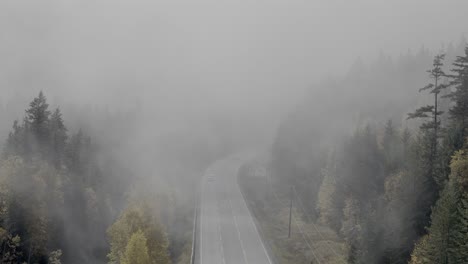 autumn veil: aerial views of fog-enshrouded highway 24 near little fort, bc