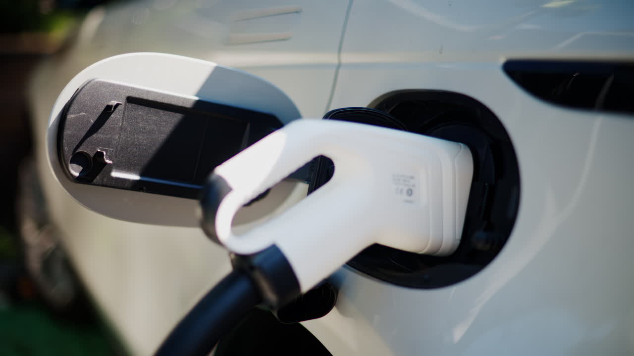 Close up of a white electric car charging