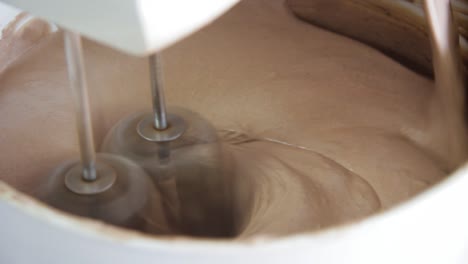 close up of a food mixer making chocolate cake dough