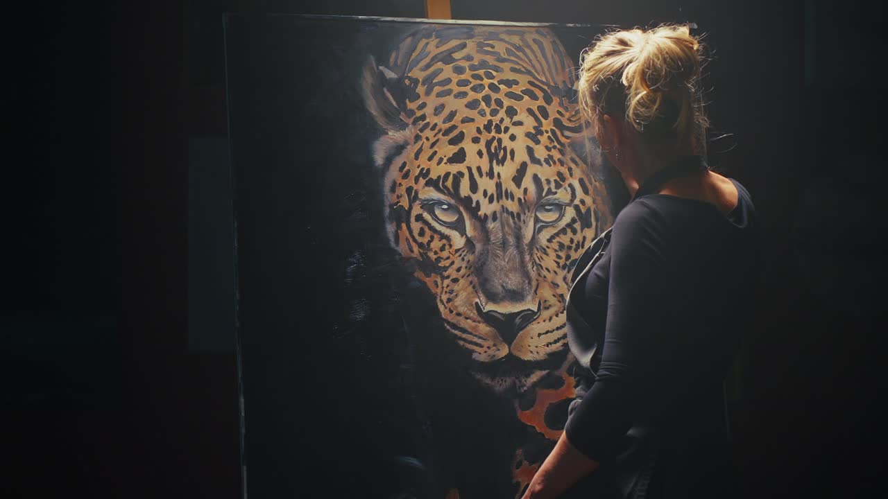 Woman Looking at Painting of a Leopard