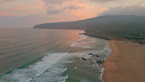 amazing sunrise sea shore aerial view. foamy waves rolling to sandy empty beach