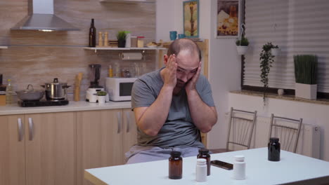 man with headache using smartphone