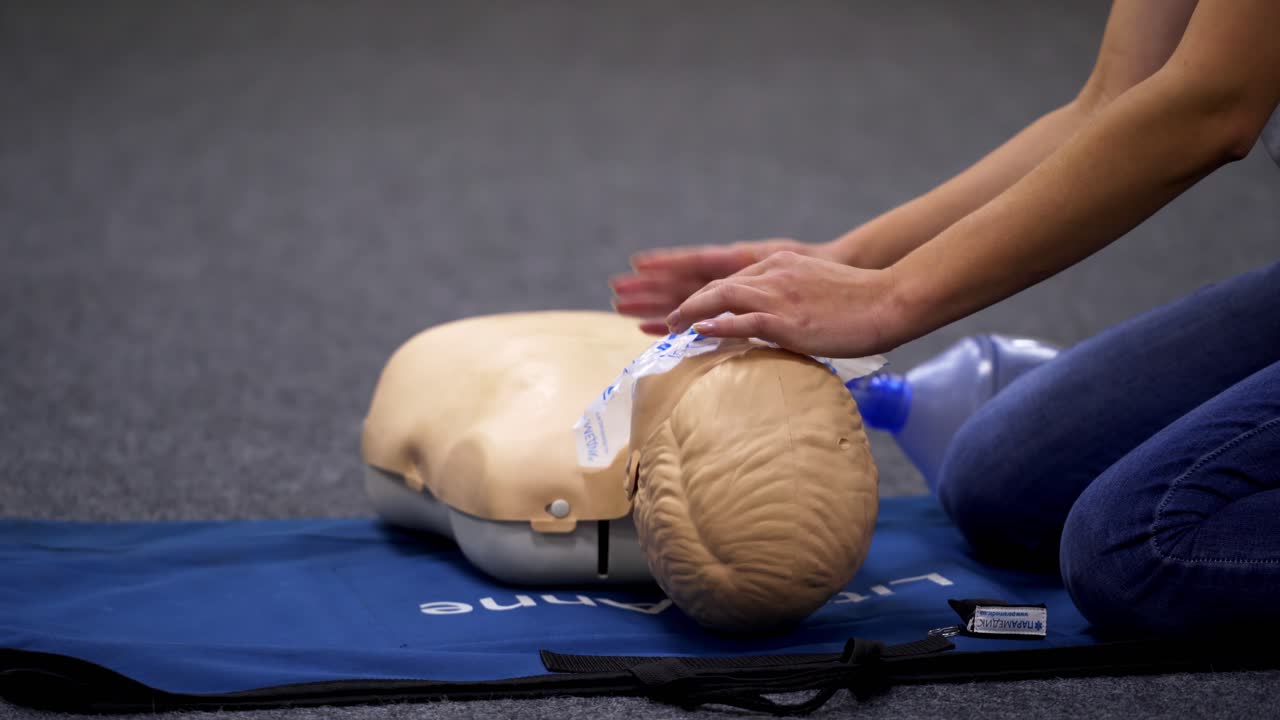 First aid class for baby. Specialist using dummy for giving training