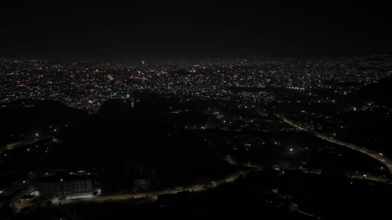 Aerial night drone footage of Kathmandu and Bhaktapur during Diwali (Tihar), glowing with colorful lights, decorations, and candles that highlight Nepal’s festive spirit and cultural celebration