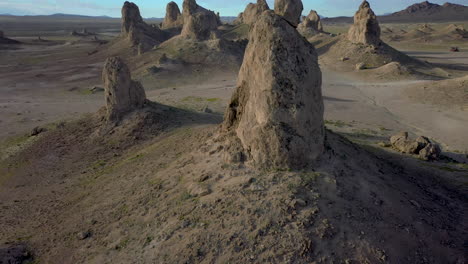 drone slowly ascending next to massive sized spires at trona pinnacles in california