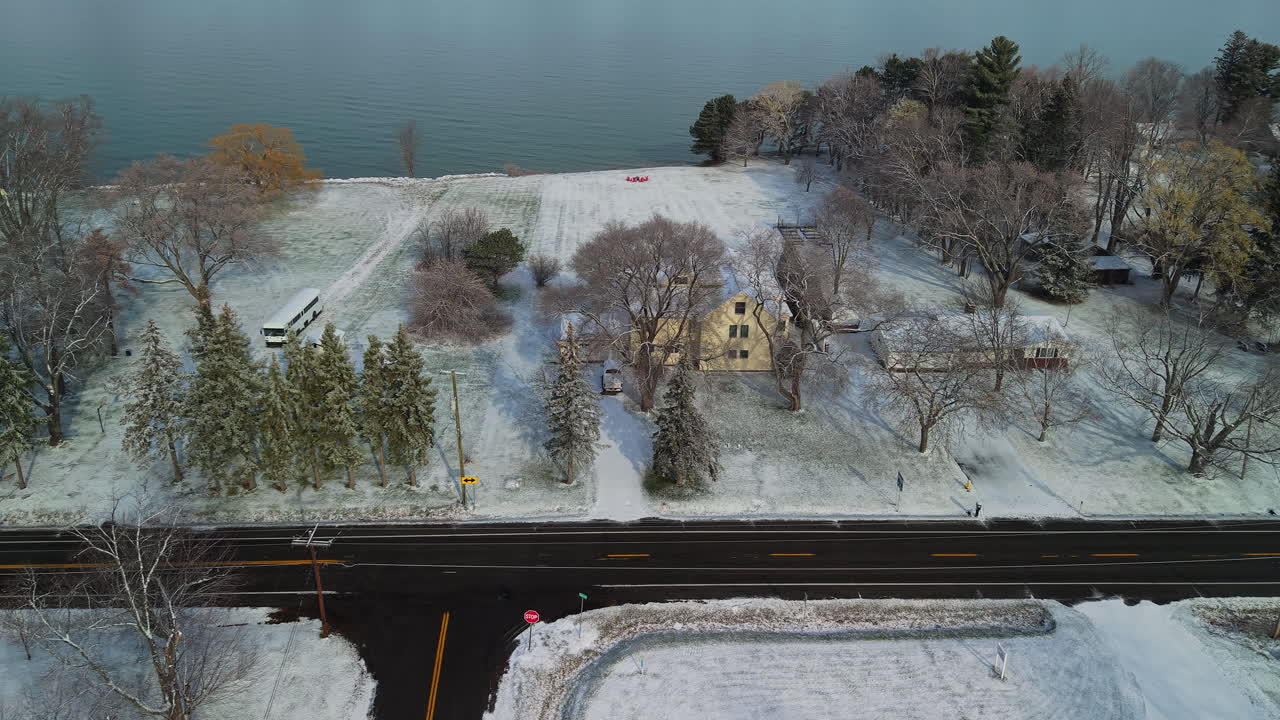 Aerial View of a Snowy Winter Landscape with Road and Houses