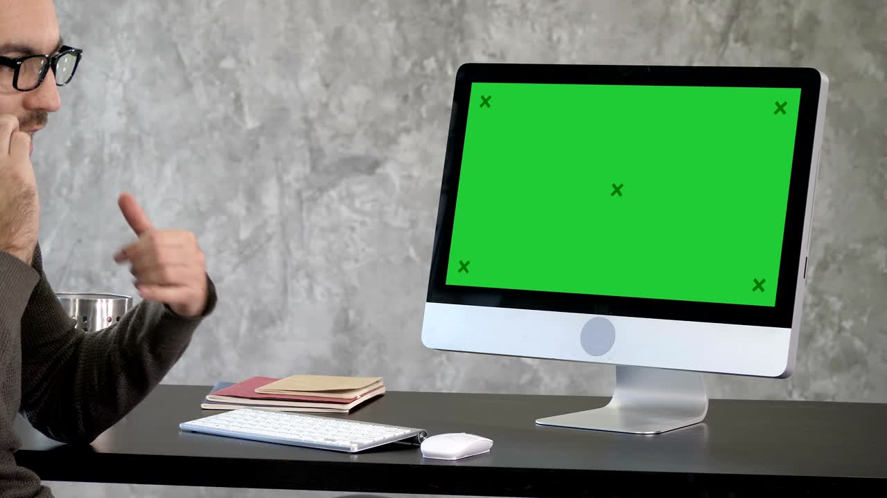 Business, people, communication and technology concept - businessman with computer calling on smartphone at office. Green Screen Mock-up Display