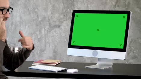 business, people, communication and technology concept - businessman with computer calling on smartphone at office. green screen mock-up display