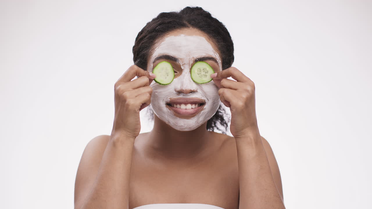 Woman with Clay Face Mask and Cucumber Slices