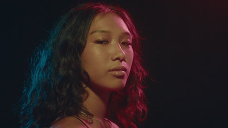 beautiful asian girl posing under neon light