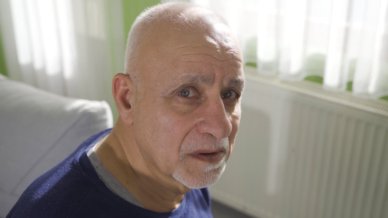 Frustrated elderly disabled grandfather feels lonely and helpless at home.