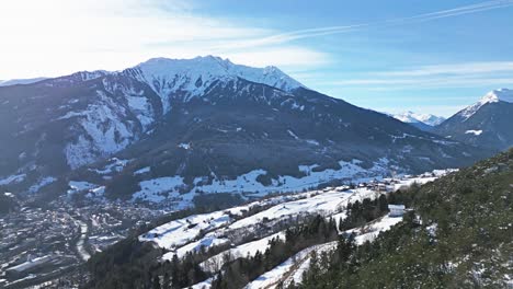 a-wintry-village-in-the-valley-surrounded-by-mountains