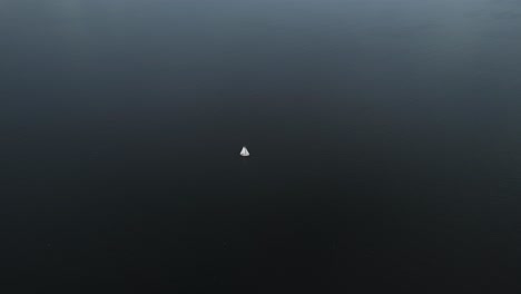 Lonely Sailboat on a Vast Ocean