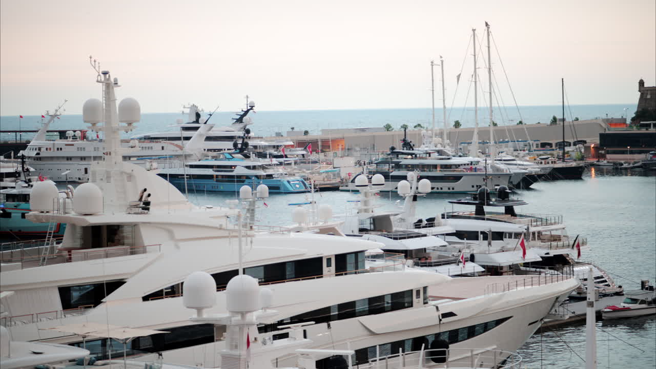 View of boats docked in the Monaco Marina with the skyline of the city on the background