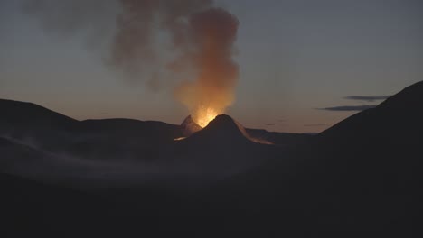 volcanic eruption at dawn in smoke filled valley iceland