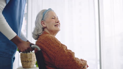 Senior-woman,-wheelchair-and-nurse-by-window