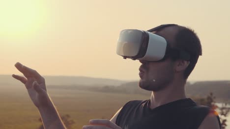 man experiencing virtual reality headset in nature at sunset