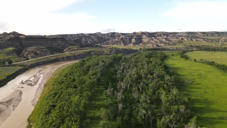 flying towards theodore roosevelt national park across the little missouri river on a summer day