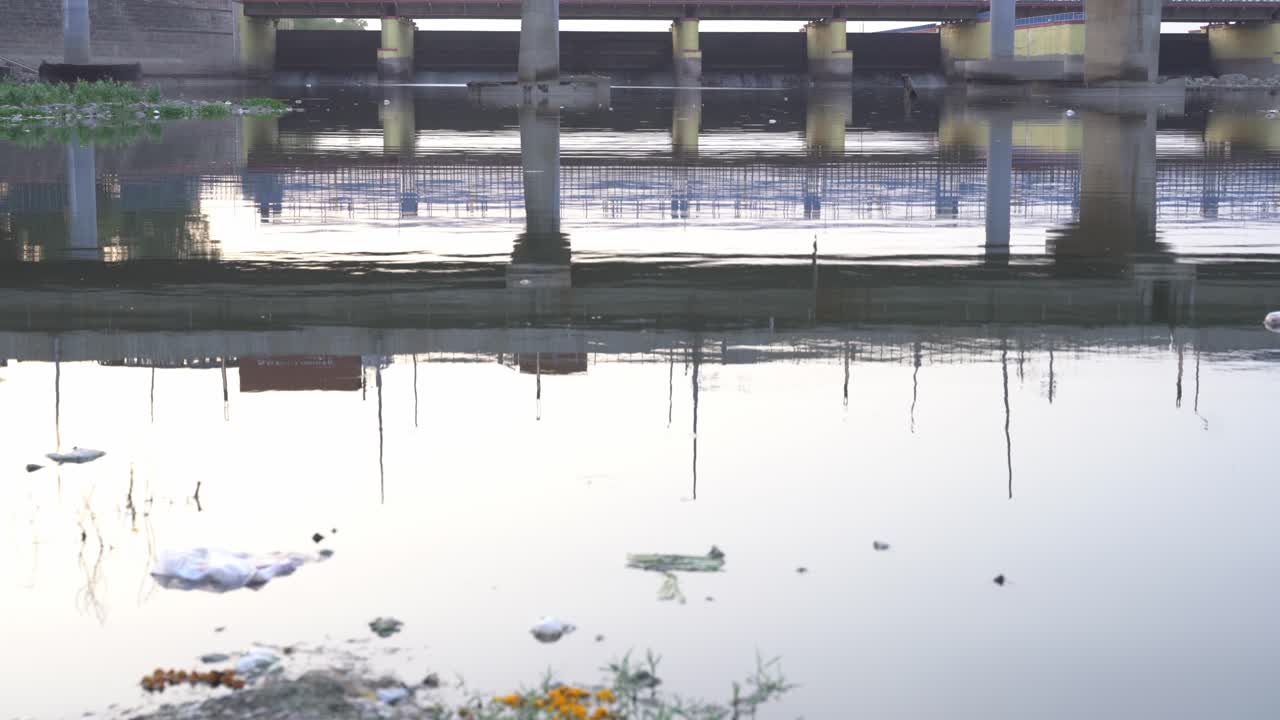 Taxic foam floating on Yamuna riverfront water surface in Kalinidi Kunj Ghat, Yamuna River port, New Delhi
