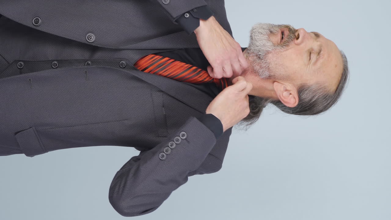 Vertical video of Old businessman experiencing shortness of breath.