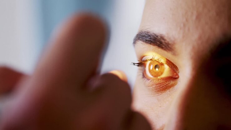 Hand of male doctor examining female patient eyes