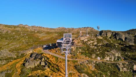 tilt drone shot of closed ski chairlift at thredbo during summer in snowy mountains, nsw, australia