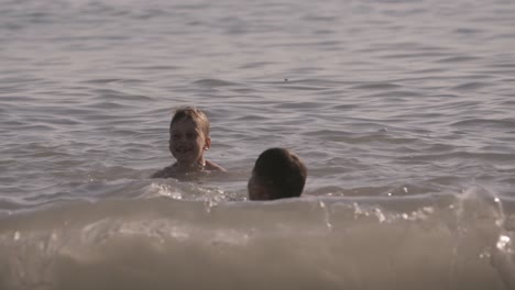 children playing in the ocean