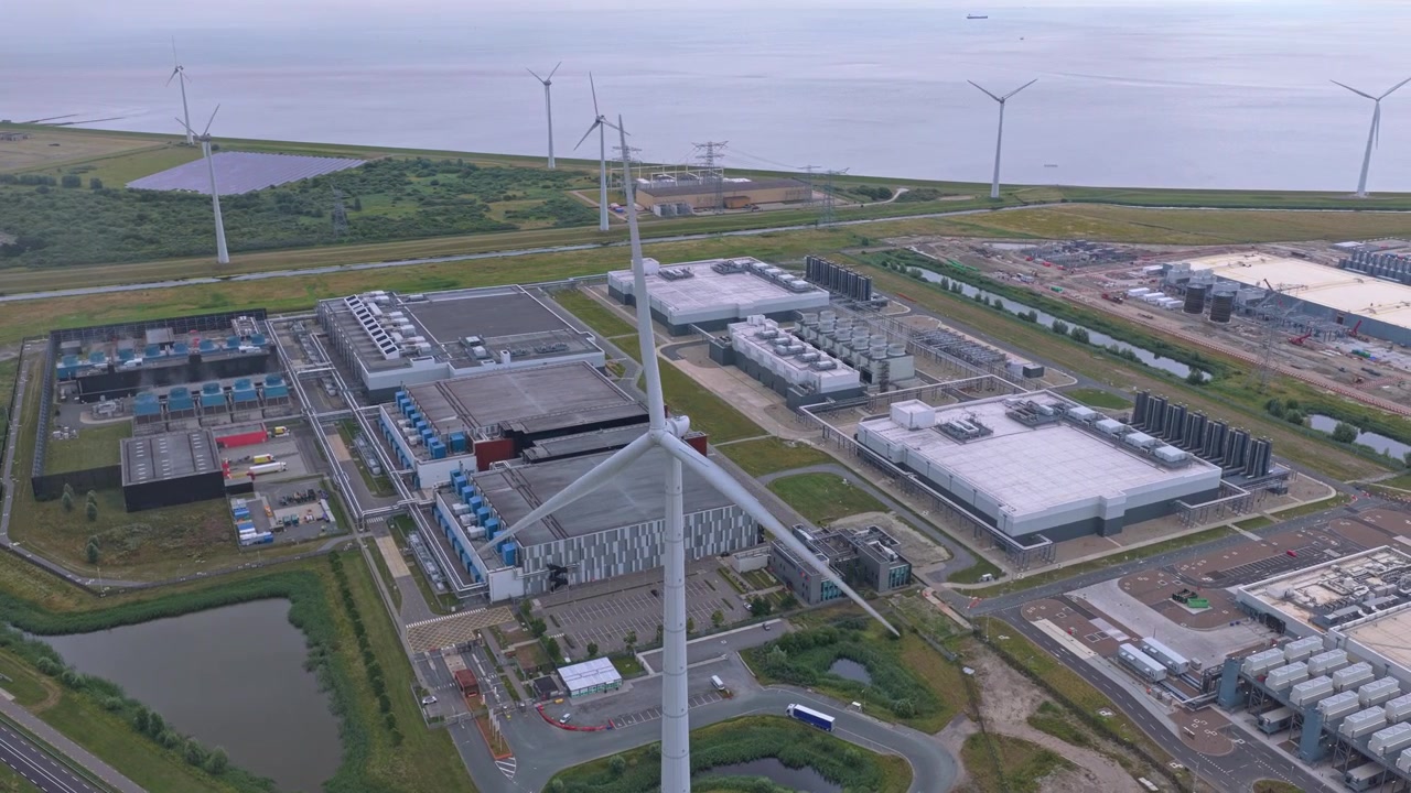 Hyperscale data center campus powered by wind turbines aerial view