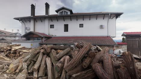 stockpile of winter firewood for domestic home log fire heating pan left