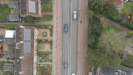 Top-down-aerial-of-cars-driving-over-road