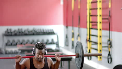 fit african american man lifting weights at the gym