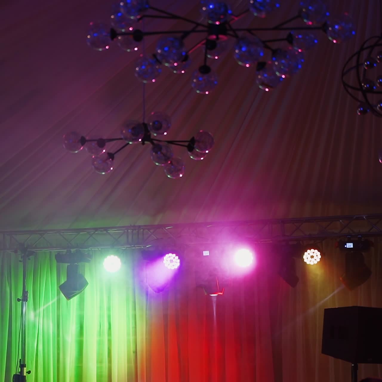 Flashing colorful lights over the stage. Bright lasers shining brightly and shimmering in the modern night club.