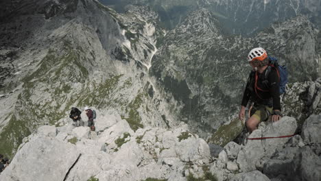 a shot of hikers climbing up the mountain, birdseye perspective, great view into the valley