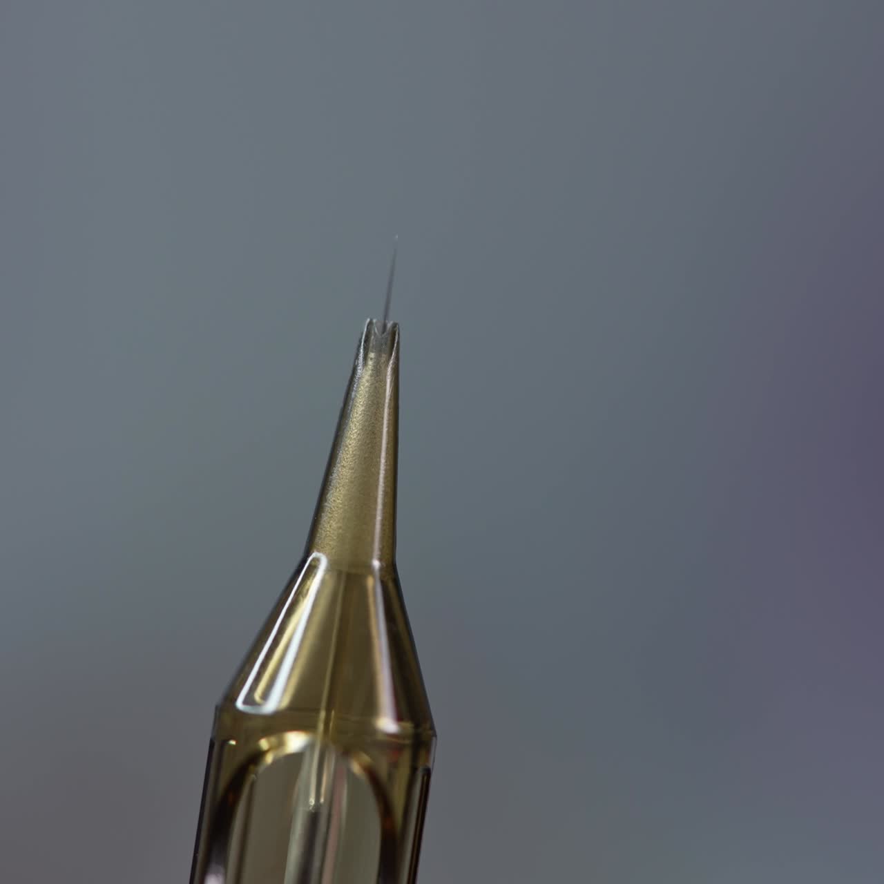 The cosmetologist checks the needle. Preparation of the needle before eyebrow tattooing