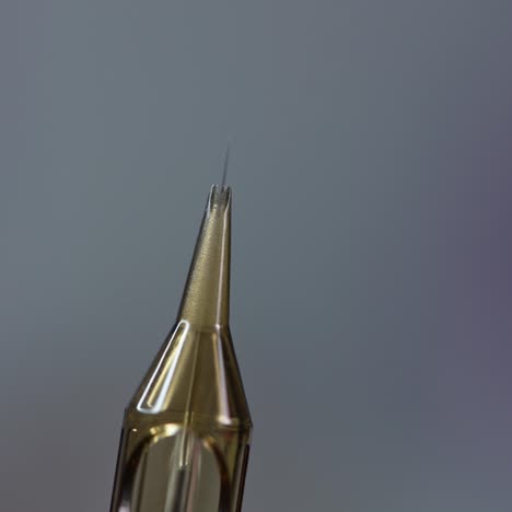 the cosmetologist checks the needle. preparation of the needle before eyebrow tattooing