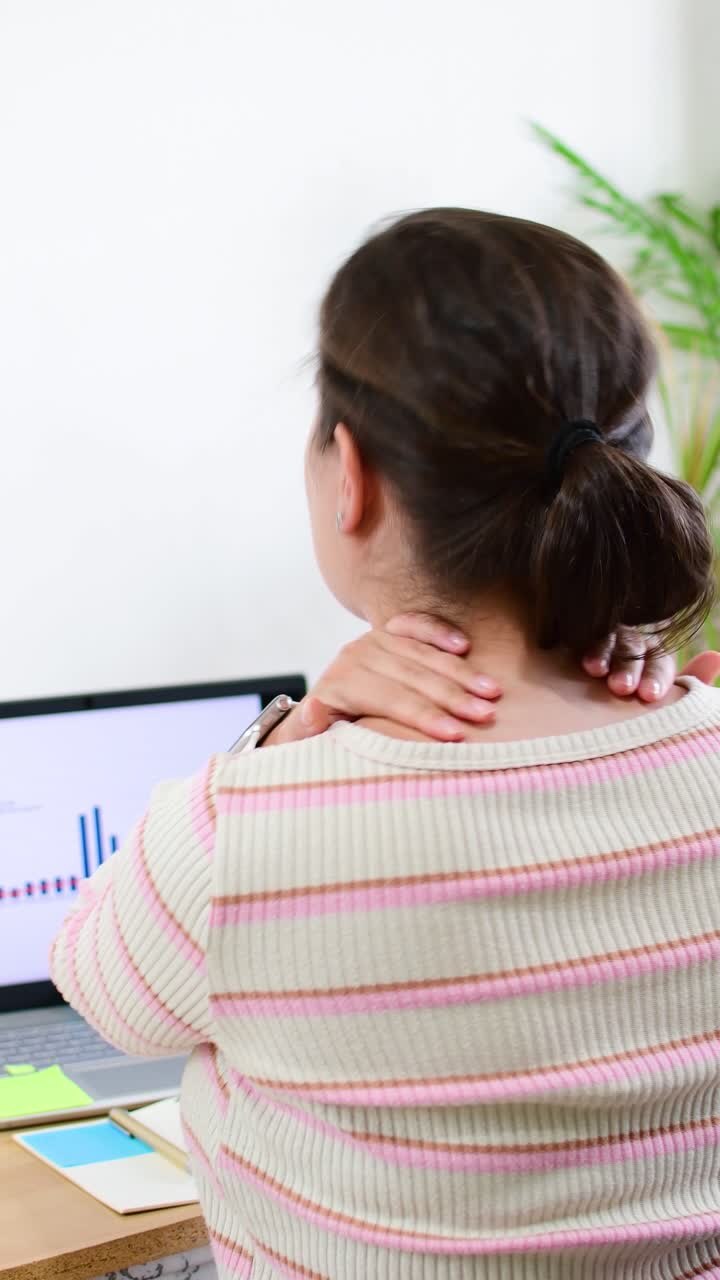 Tired stressed businesswoman suffering from neck pain working from home office.
