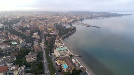 Drone-aerial-view-flies-over-Italian-city-on-Lake-Garda