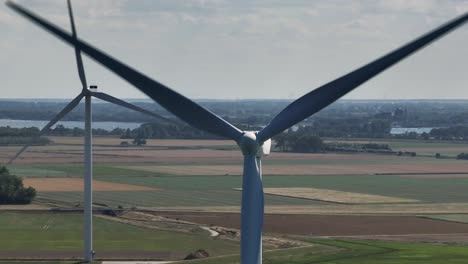 aerial orbit shot of rotating wind turbines and delta works in oosterscheldekering,netherlands