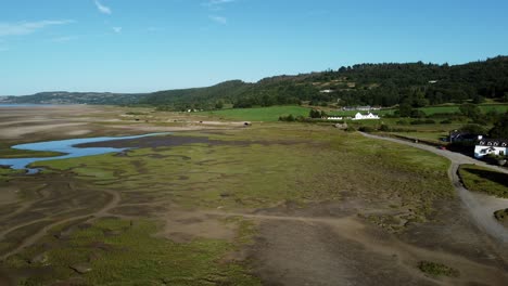 aerial view traeth coch scenic salt marsh moorland green hills countryside at sunset