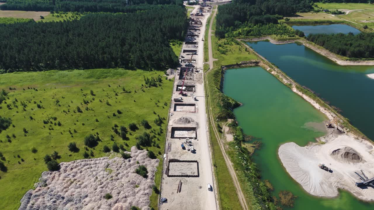 Massive construction site of Rail Baltica bridge, preparing places for columns, aerial view