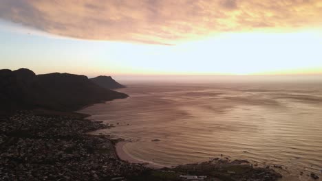 girl dancing on the top of lion's head in cape town south africa at sunset - aerial shot