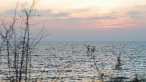 Romantic-sunset-in-to-the-sea-though-the-clouds