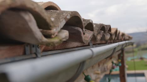 old clay tiles and a clean gutter closeup