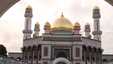 Peering-through-the-arched-doorway-towards-Jame'-Asr-Hassanil-Bolkiah-Mosque-in-Bandar-Seri-Bagawan-in-Brunei-Darussalam-at-sunset