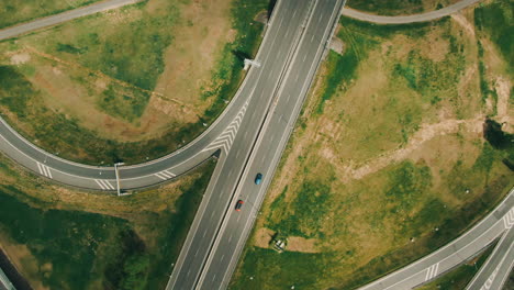 Aerial-top-down-view-on-multilevel-interchange-overpass-in-Zbraslav-showing-afternoon-traffic-under-sun-and-cloud