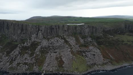 Aerial-dolly-forward-shot-of-the-geographically-prominent-Fair-Head-in-Northern-Ireland-known-for-its-stunning-coastal-cliffs-and-panoramic-views-for-hikers-and-climbers-in-the-early-morning