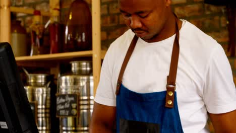male staff working at counter in supermarket 4k